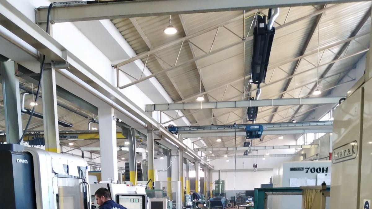 An operator in a Srebrnac Produkt jacket at a DMG CNC lathe